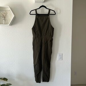 Army green cotton blend overalls. Pockets in the front and back.